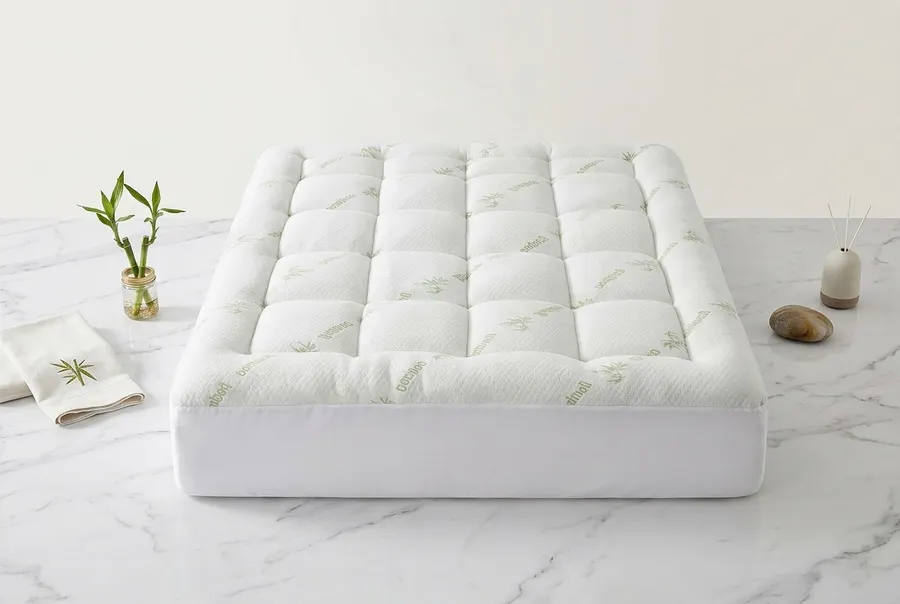 A pristine organic bamboo mattress topper rolled and standing upright on a clean bedroom surface, natural morning light st...