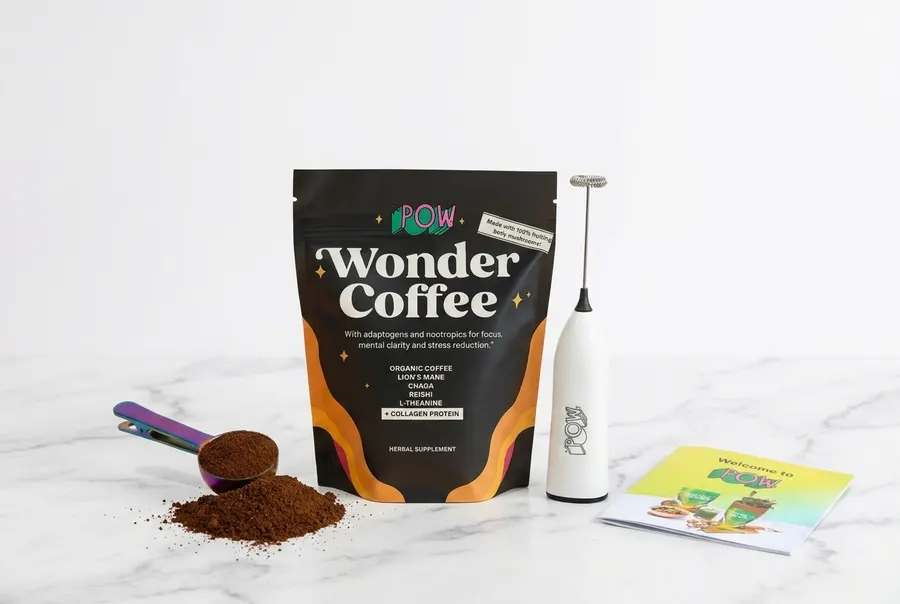 A frosted glass mug of medium-roast coffee on a clean kitchen counter, early morning soft directional light from a side wi...