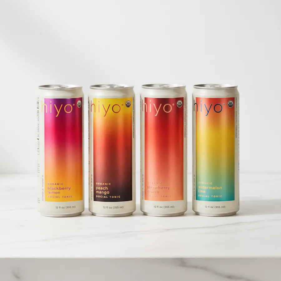 A health-conscious millennial at evening, setting down a slim metallic can of adaptogenic drink on a minimalist table, not...
