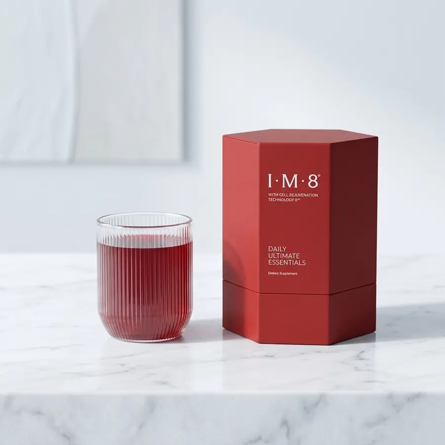 A single sleek matte powder container on a minimalist kitchen counter next to a filled glass of water and a measuring scoo...