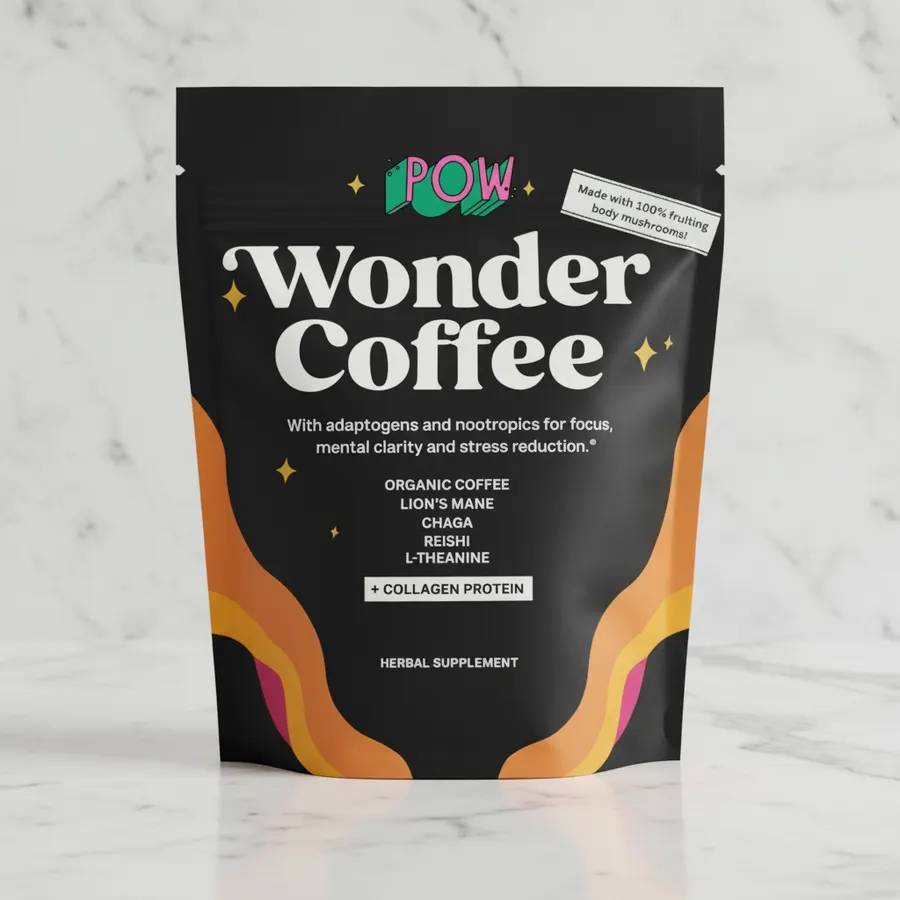 Flat lay of Wonder Coffee Starter Pack contents artfully arranged on a minimalist desk—coffee scoop, powder, measuring spo...