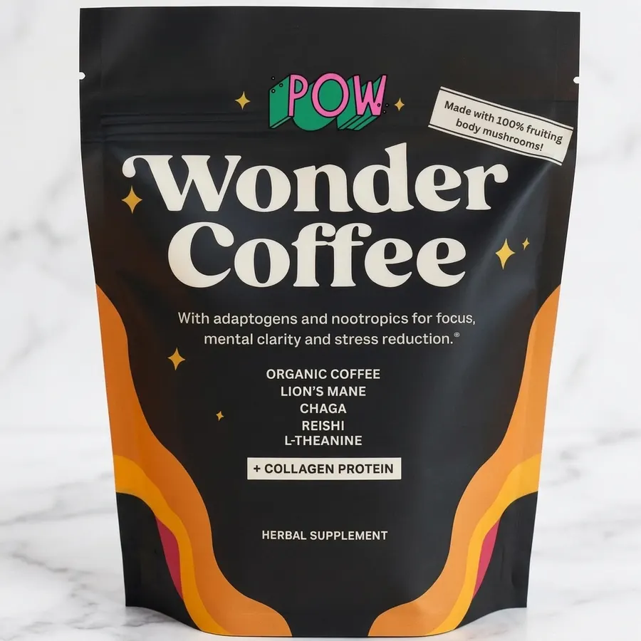 A single-serving sachet of coffee blend centered on a seamless two-tone backdrop with warm terracotta (#ff6b35) on the lef...