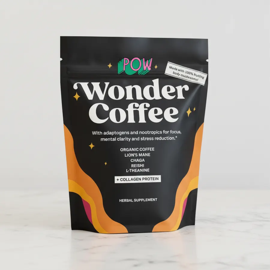 Close-up of multiple disappointing mushroom coffee products and packets spread on a desk, with a skeptical hand examining ...