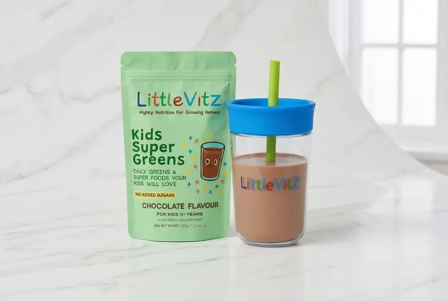A matte tub of kids' chocolate super greens powder centered on a clean white surface, the tub upright occupying 60% of fra...