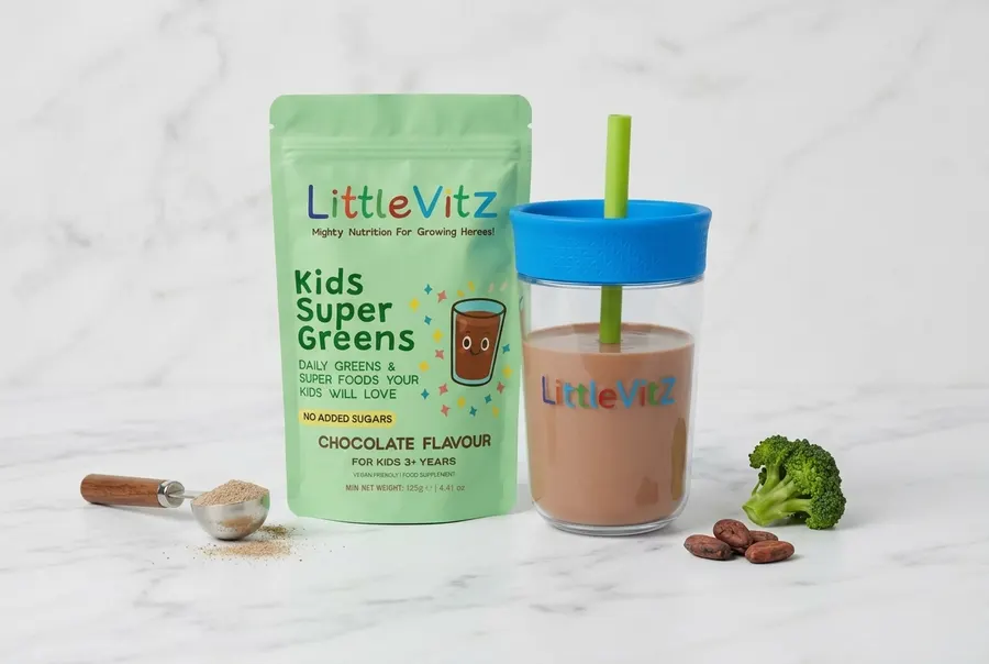 Clean product shot of LittleVitz supplement packaging on a white marble surface, soft , sharp focus, professional but appr...