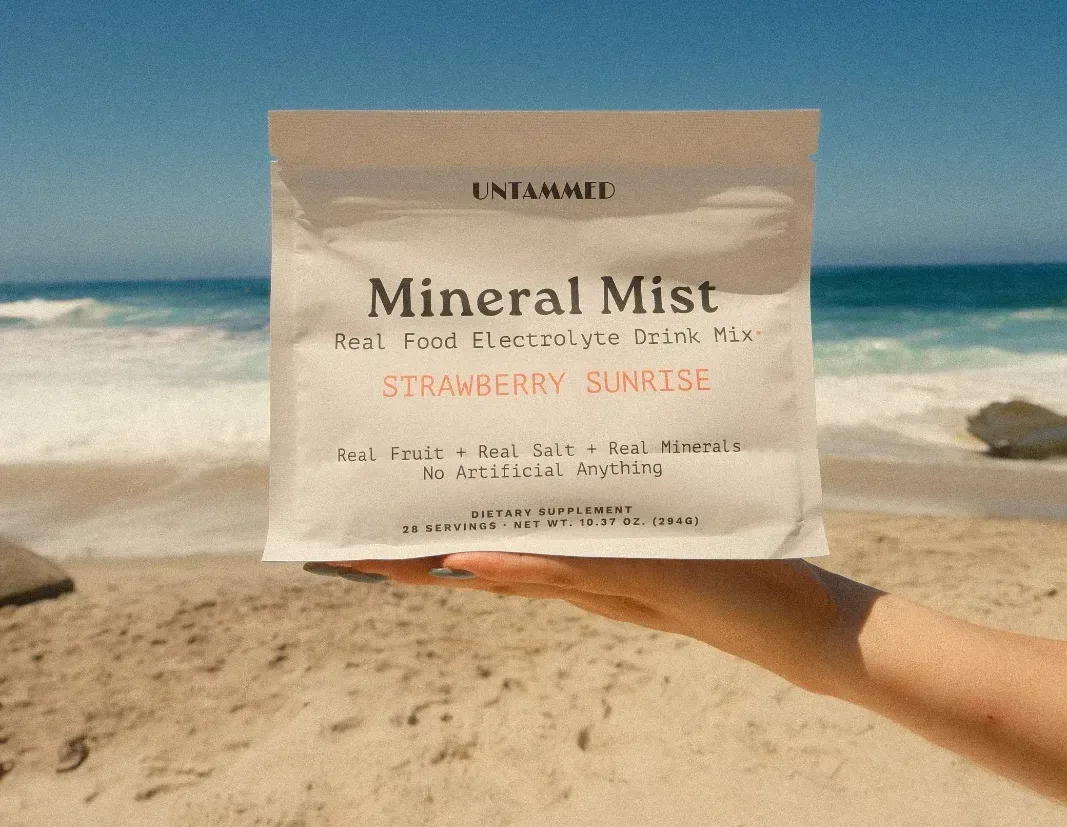 photograph of Untammed in a real in-use moment — the product placed or held prominently in a warm, authentic everyday sett...